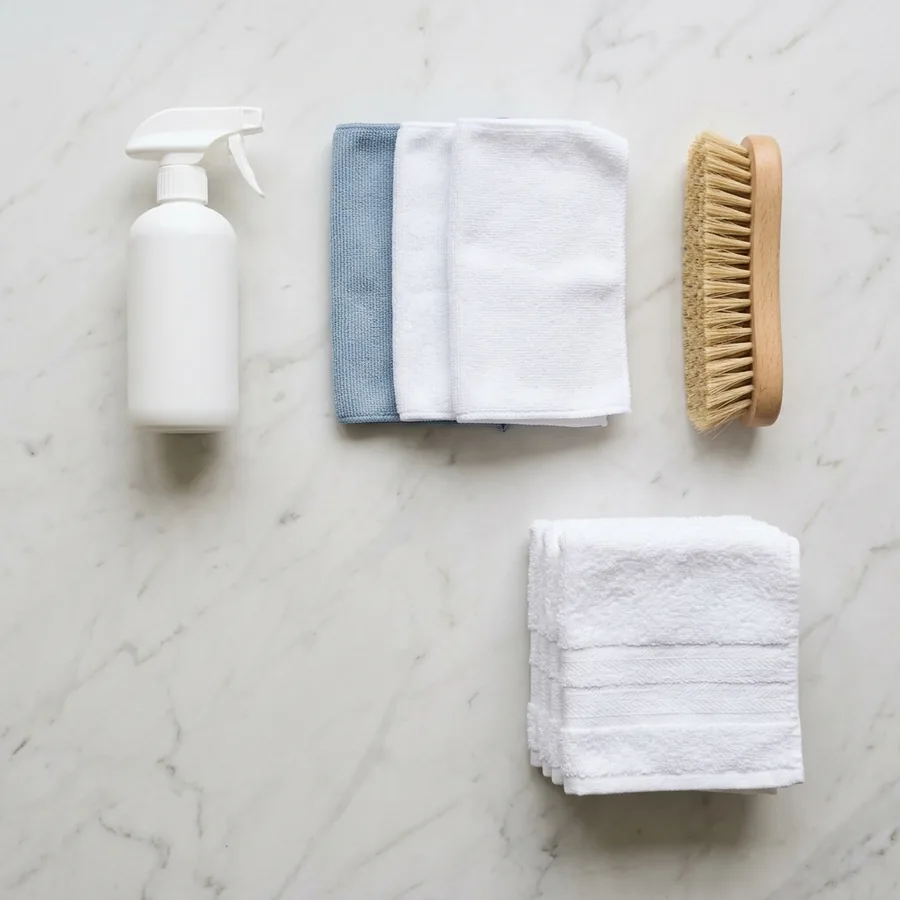 Professional cleaning supplies arranged neatly on a marble surface